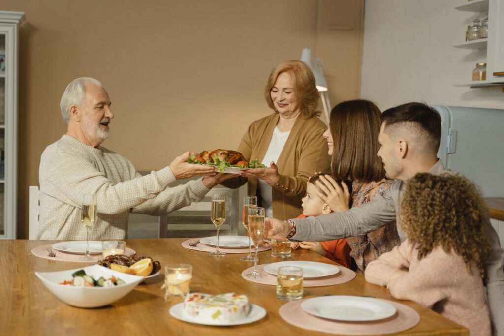 A family shares a joyful Thanksgiving dinner together at home.